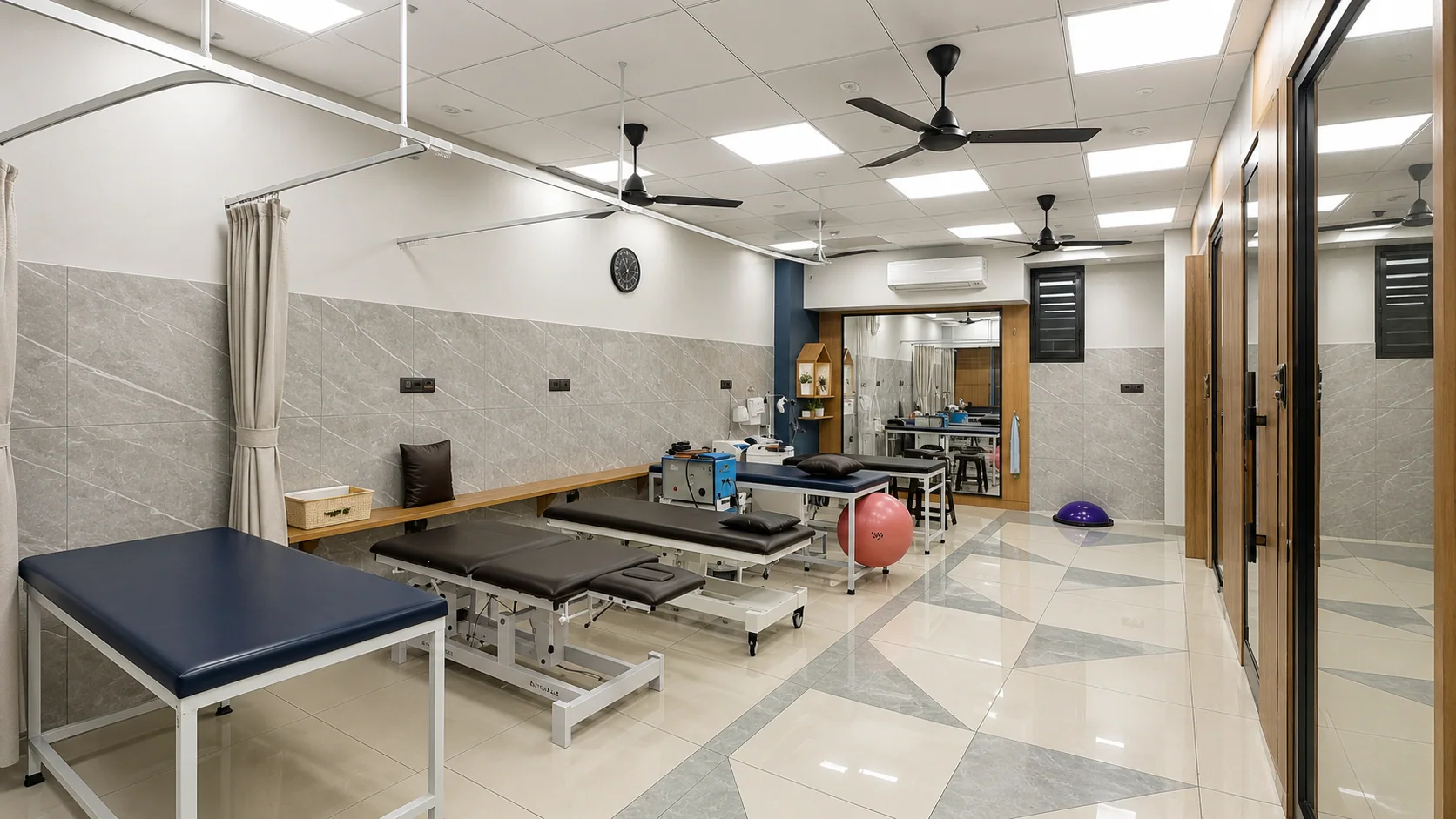 Wide view of the bright Sai Om rehabilitation floor with treatment tables